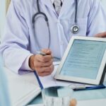 unrecognizable-doctor-extending-digital-tab-anonymous-patient-fill-questionnaire_1098-19318.jpg